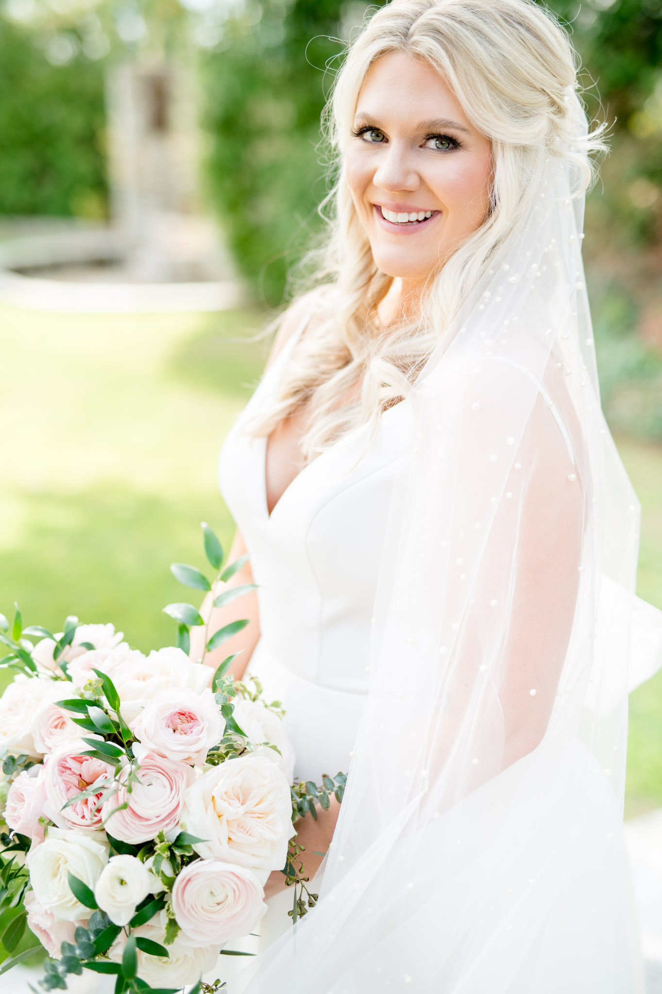 Bride smiles and laughs at camera.