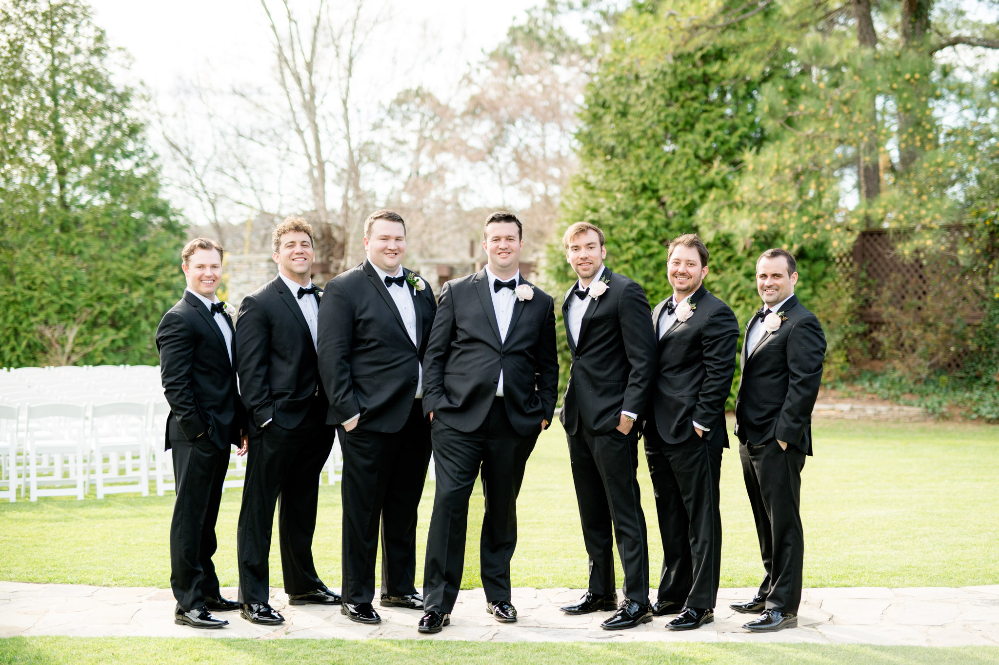 Groom and groomsmen smile.