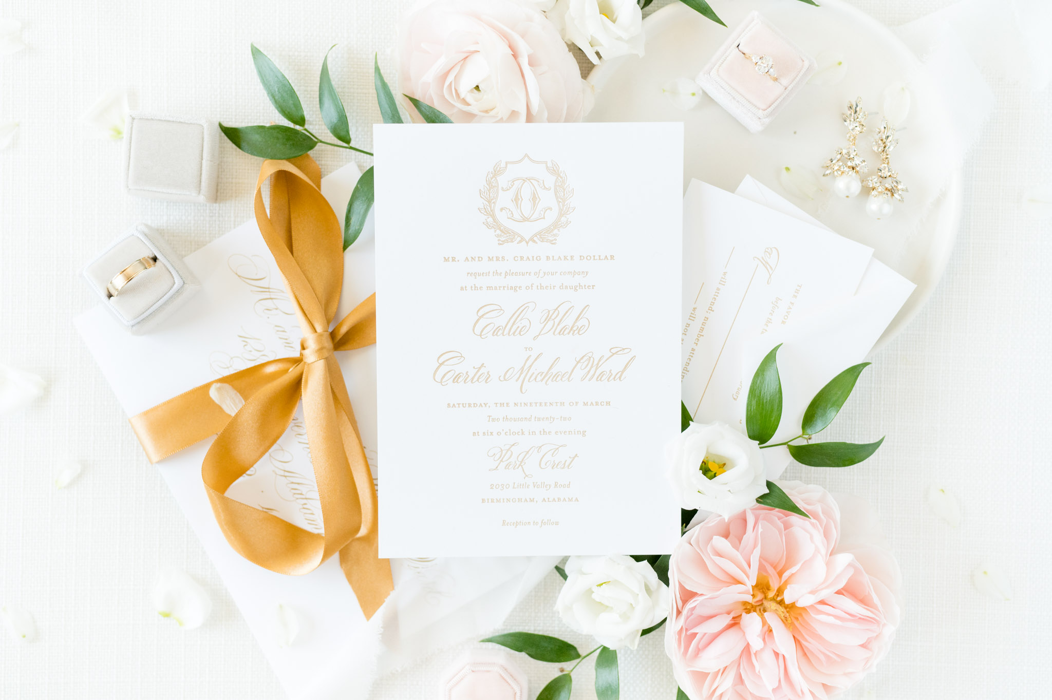 Wedding invitation sits with other pieces of suite.
