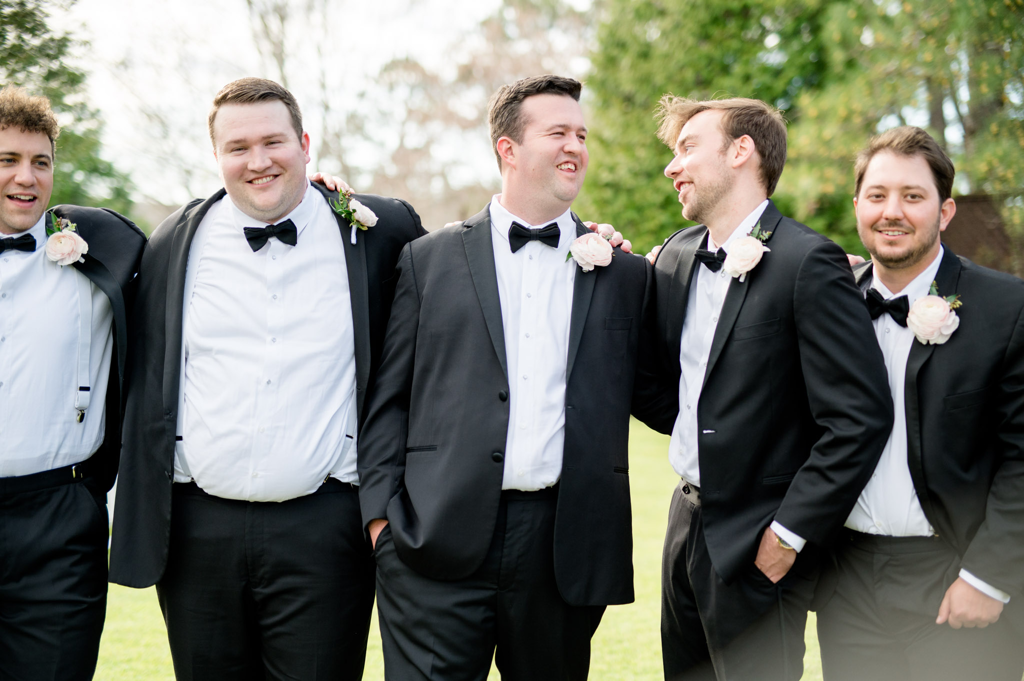 Groom jokes with groomsmen.