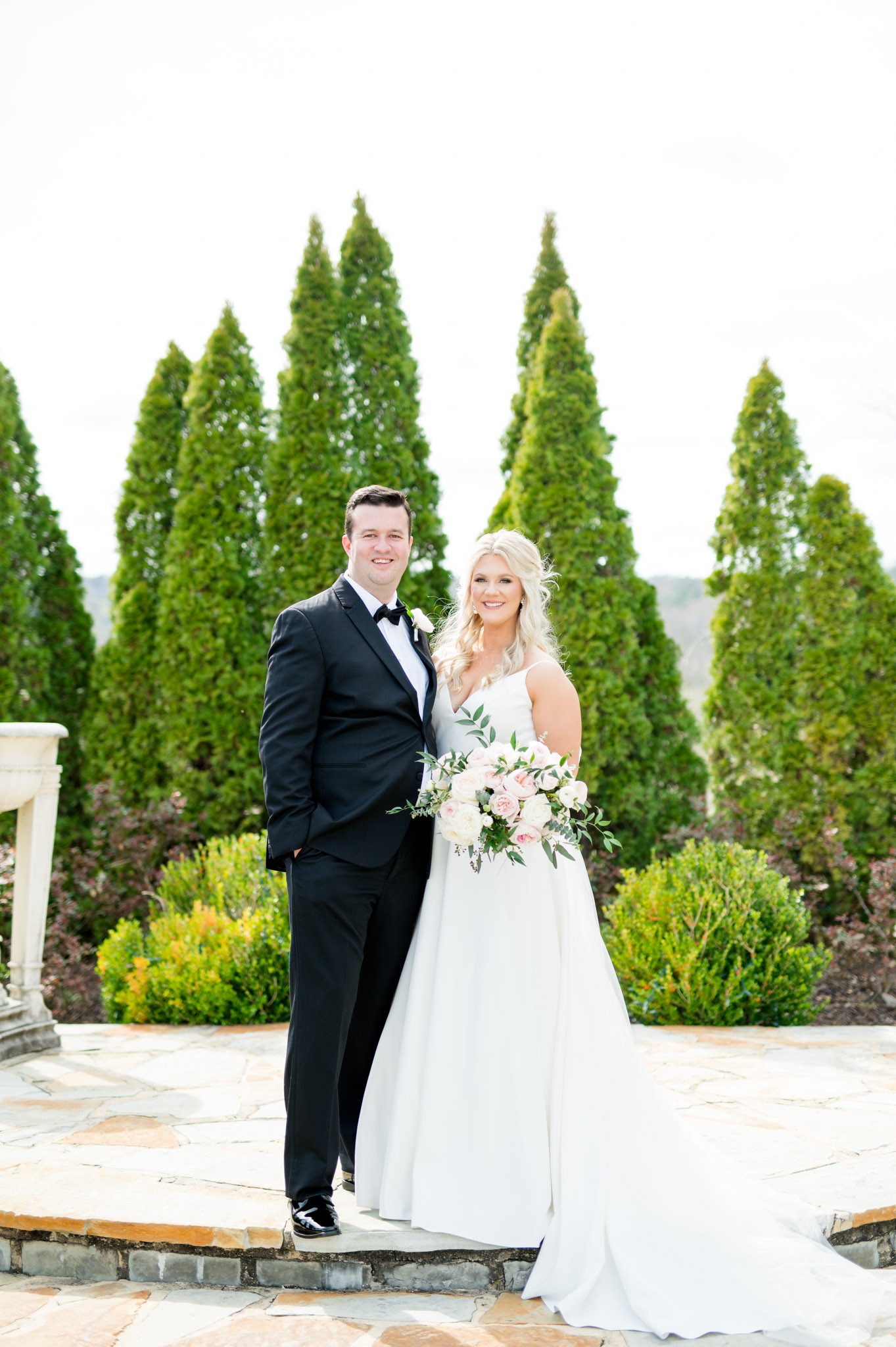 Bride and groom smile at camera.