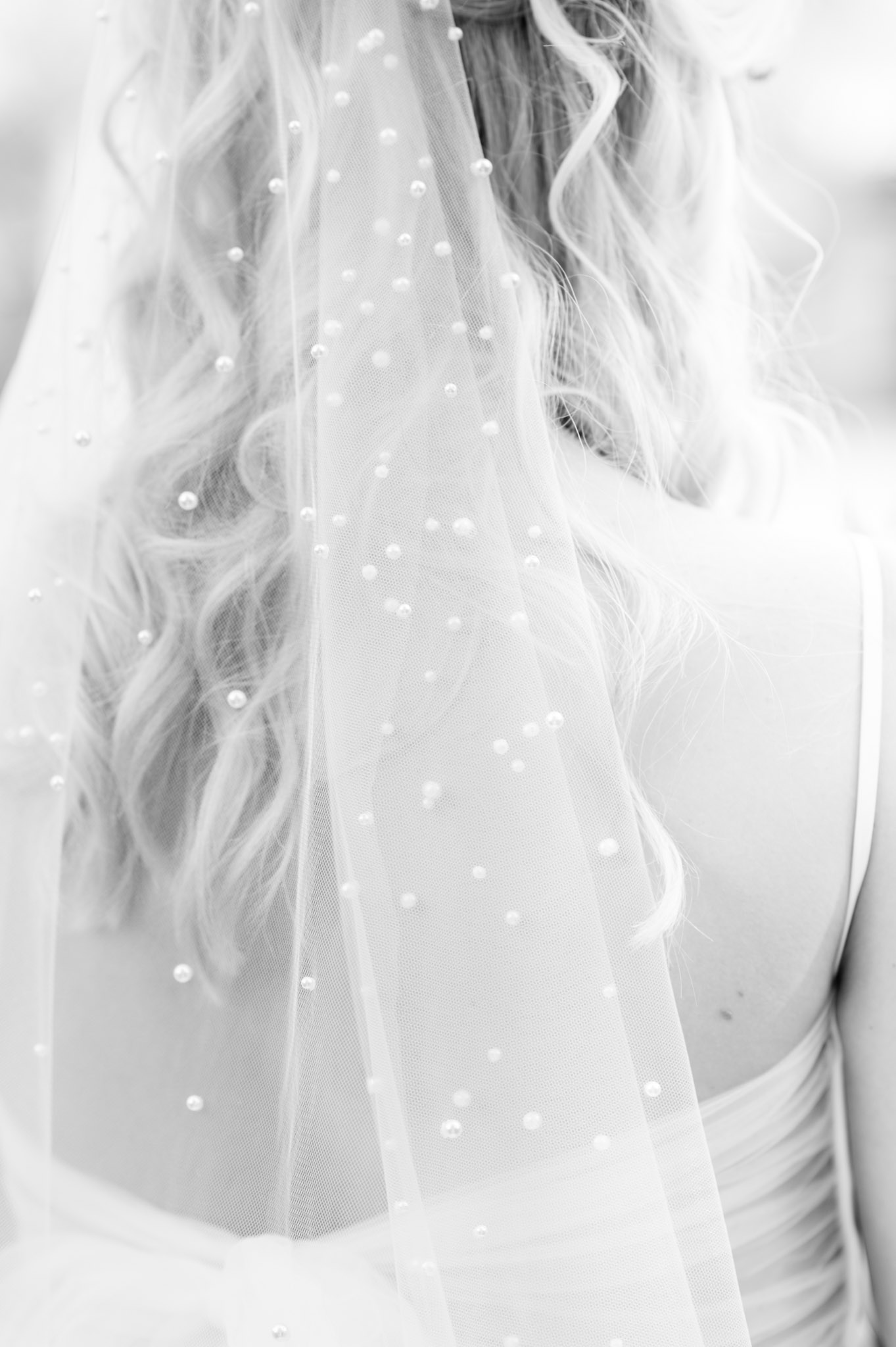 Closeup of pearl detailing in bride's veil.