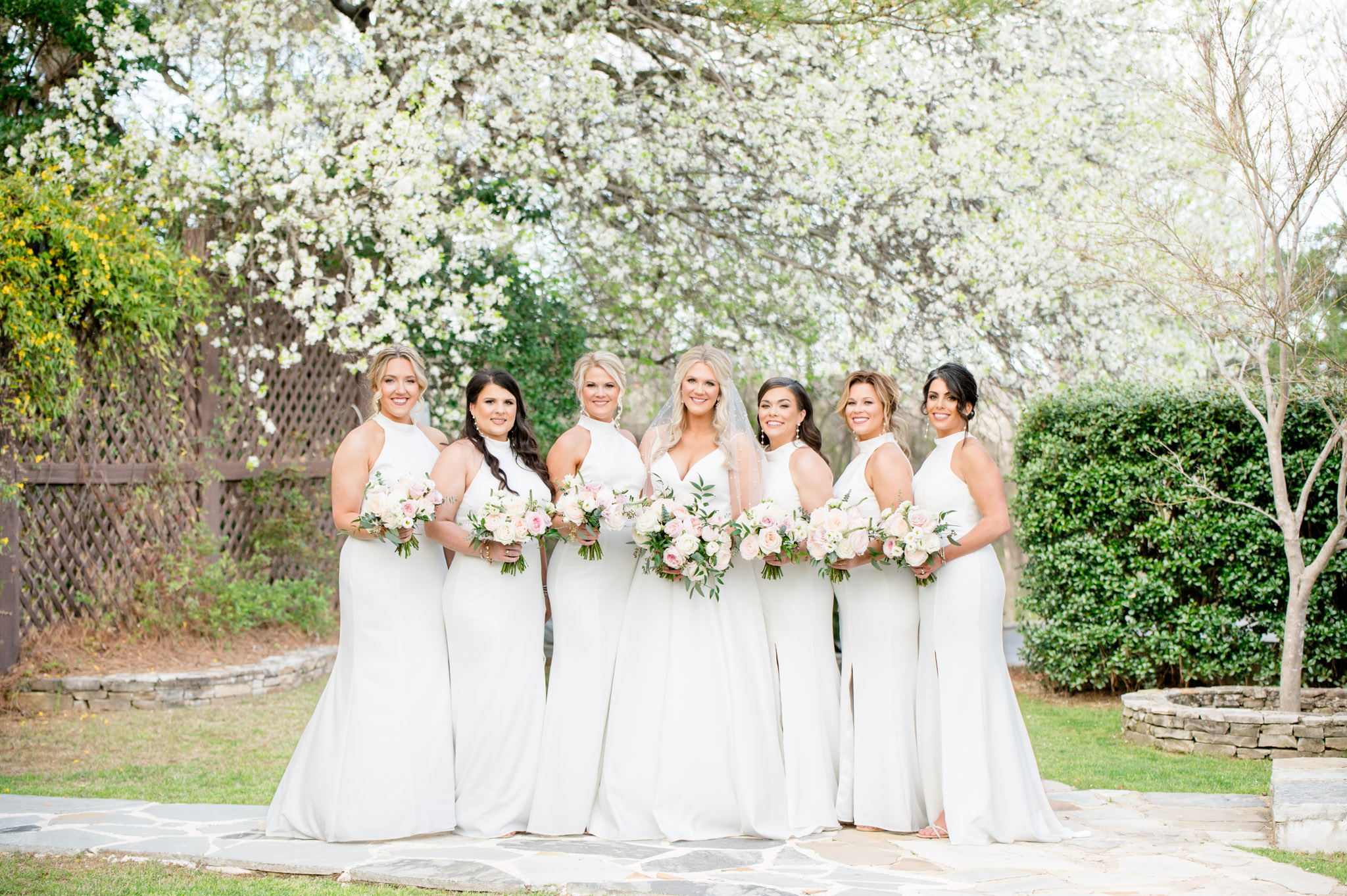 Bride and bridesmaids smile for portraits.